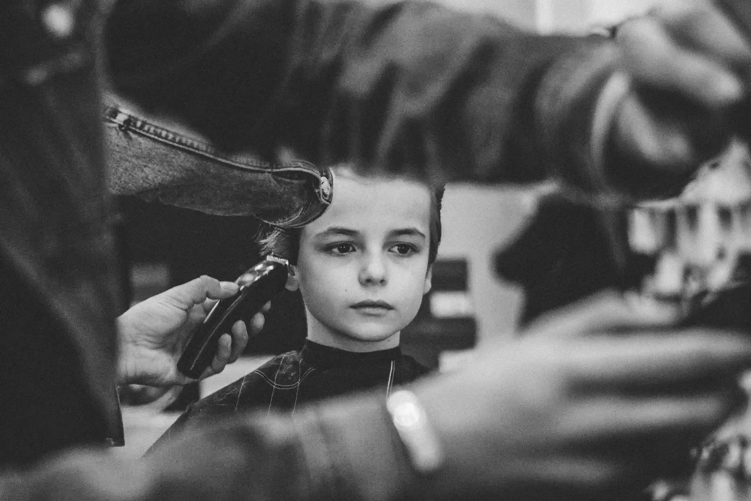Child getting a haircut at Clipper Craft Barbershop, a kid-friendly barbershop in Edmonton